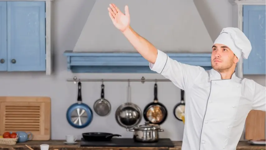 Chef in a commercial kitchen preparing orders for several brands